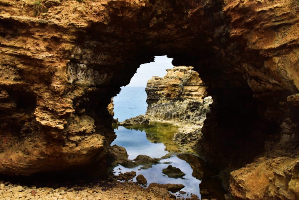 a cave with a view of the water