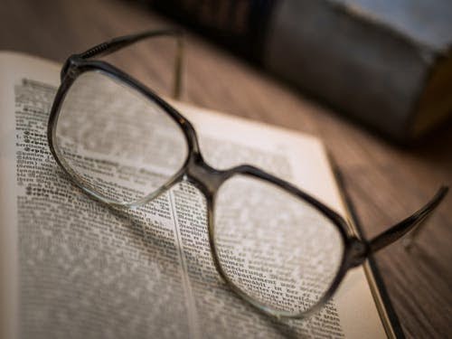 a pair of glasses on a book
