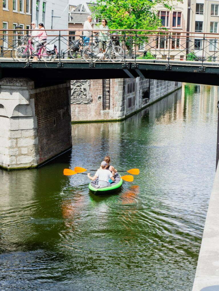 people in a boat on a canal
