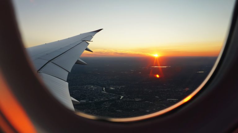 an airplane wing and the sunset